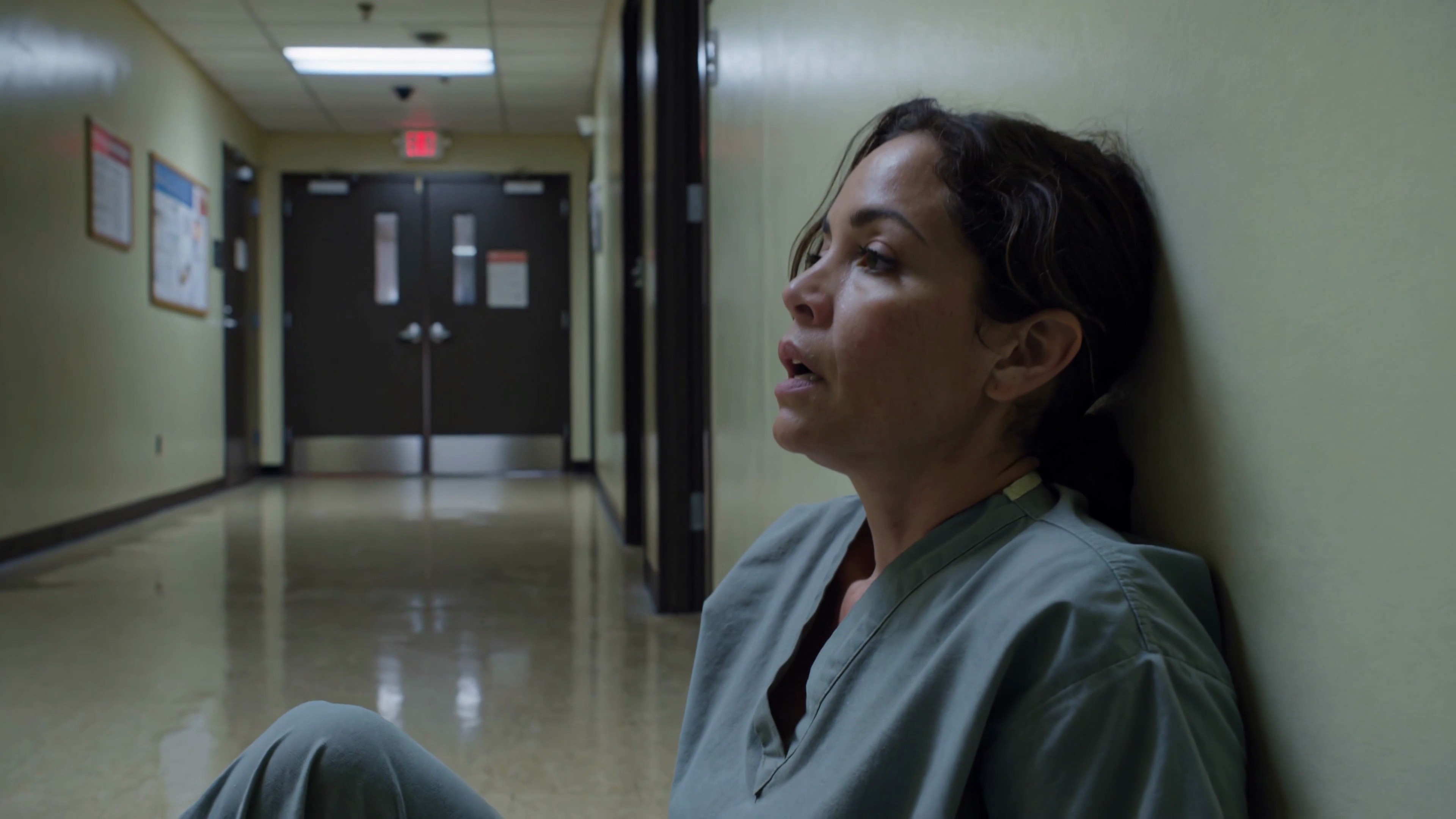 Exhausted vet sitting in a corridor after a long shift